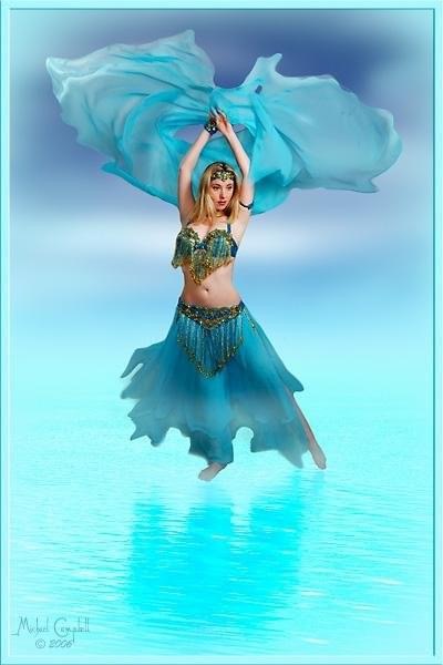 Erin McGurk holding a sheer turquoise veil above her head